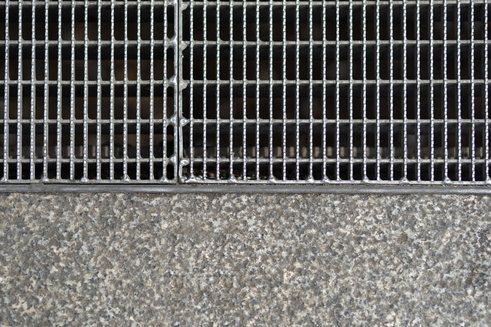 Metal drainage grate set into concrete