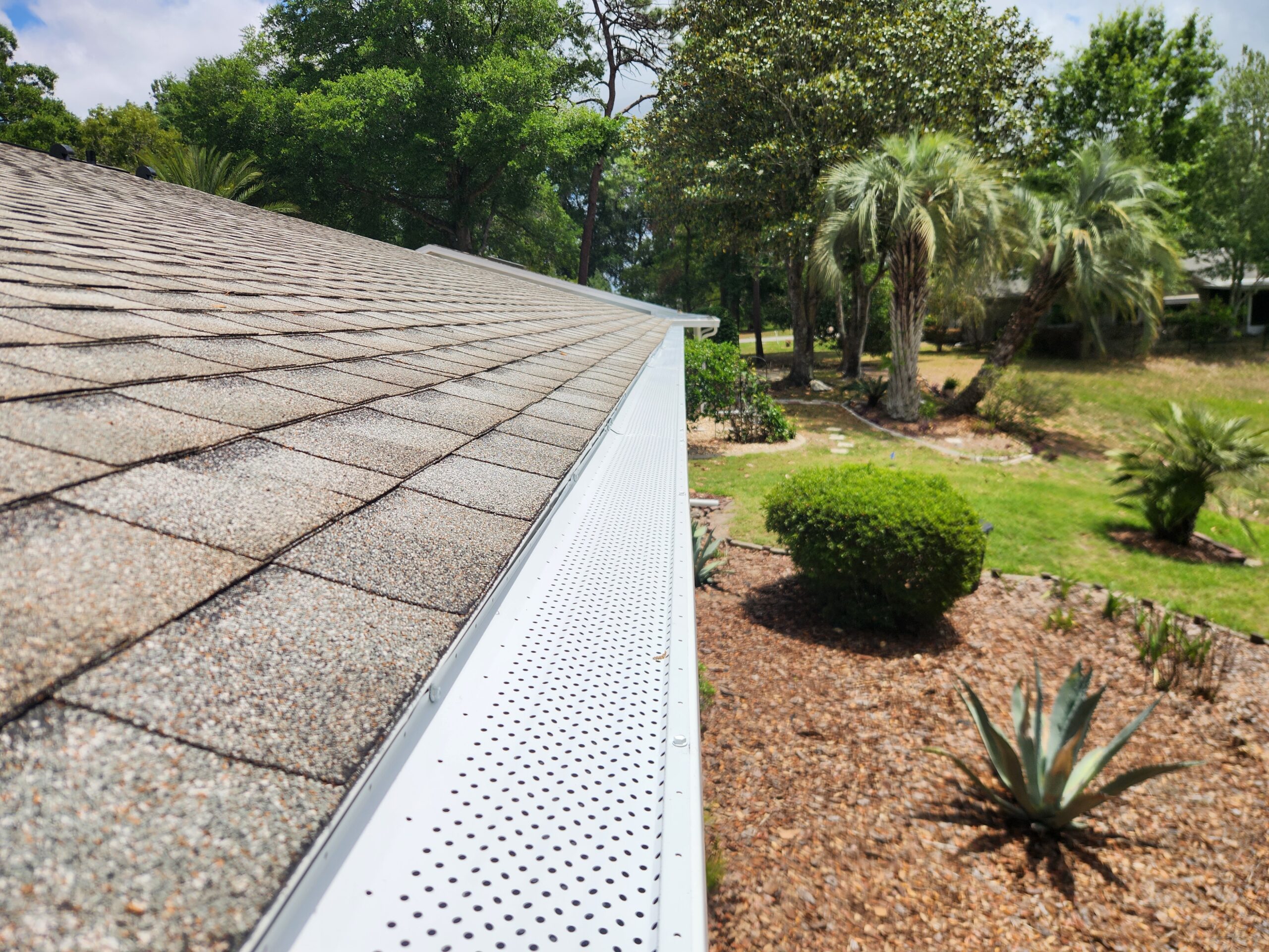 Premium Leaf Guards micro-mesh leaf guard installed along a seamless aluminum gutter on an Ocala, Florida home